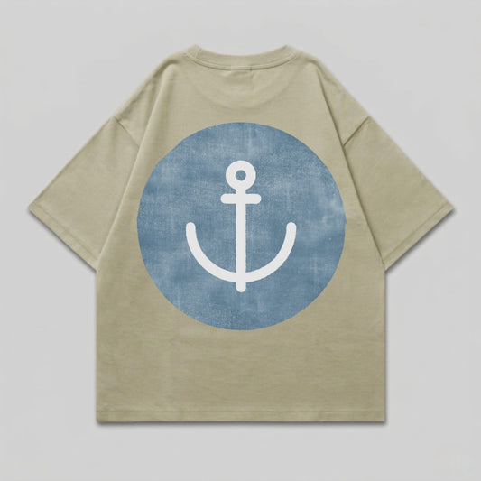 Tan t-shirt with a blue circle containing a white anchor graphic on the back.