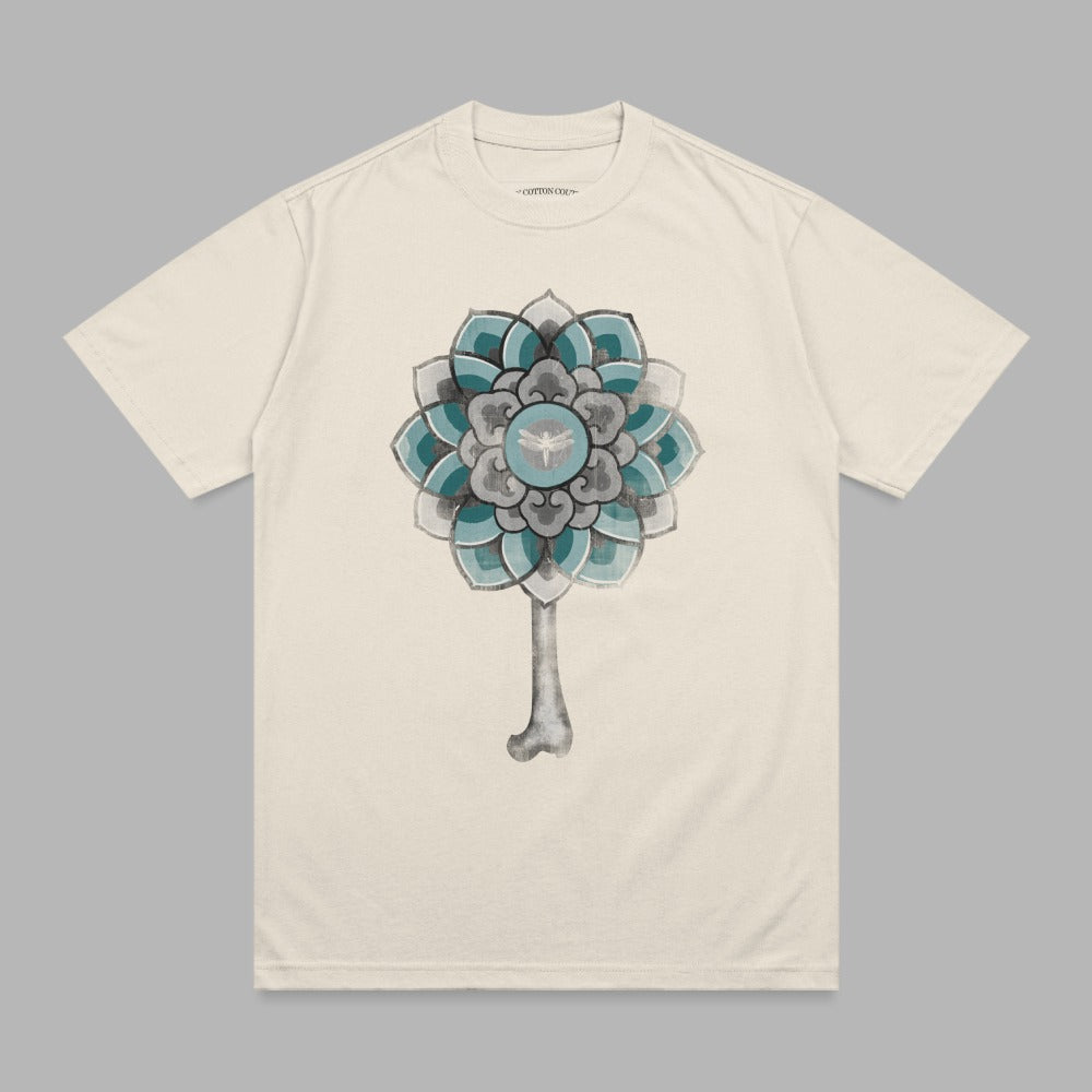 Cream t-shirt with a circular mandala-style design featuring blue, teal, and gray.