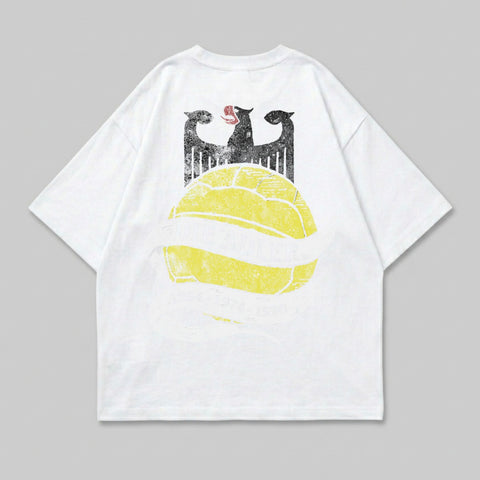 White t-shirt with eagle crest and yellow soccer ball graphic.