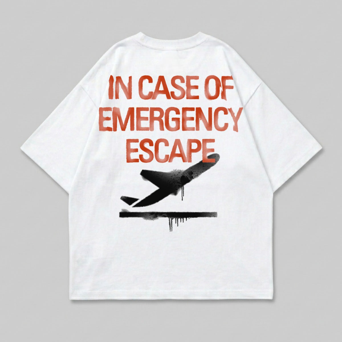 White t-shirt with red text "IN CASE OF EMERGENCY ESCAPE" and a black airplane graphic.