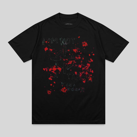 Black t-shirt with red paint splatters and "I AM NOT A TARGET I AM A WOMAN" text.