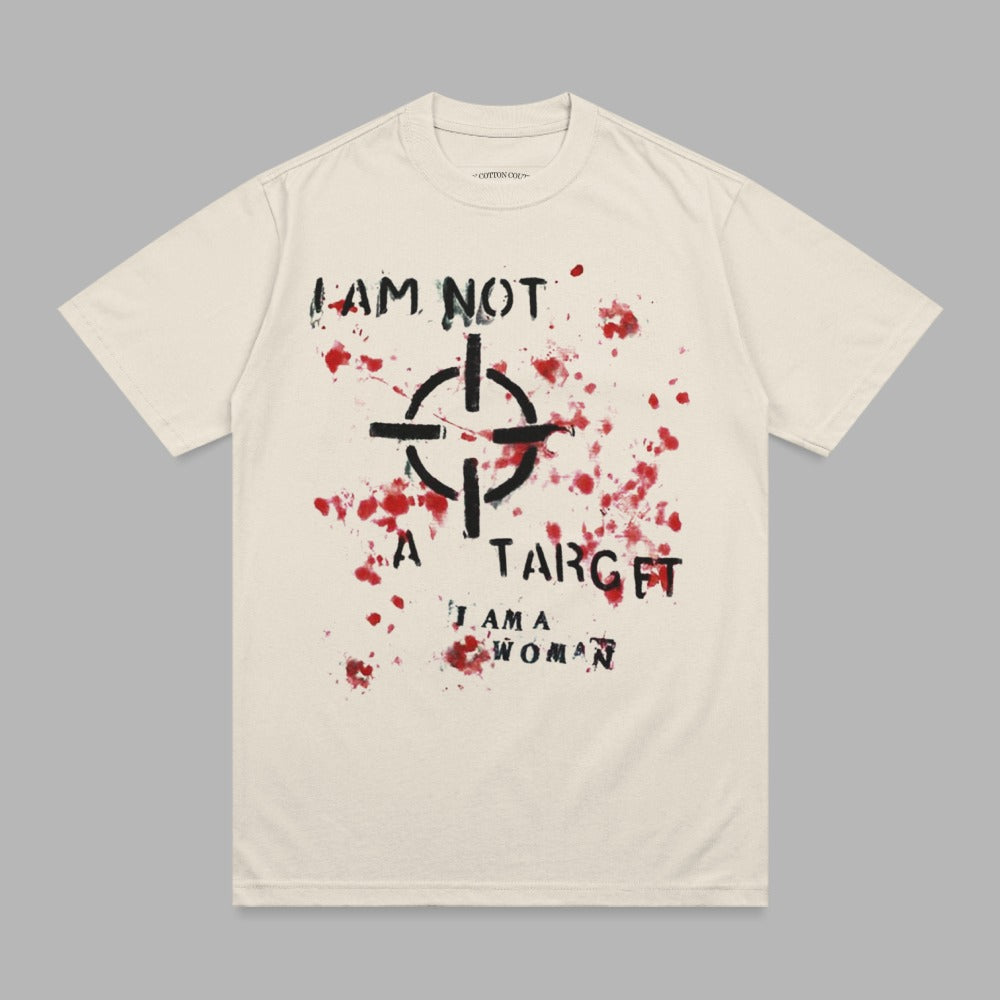 Cream t-shirt with black target and red splatter graphic and text "I AM NOT A TARGET I AM A WOMAN".