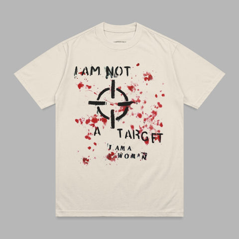 Cream t-shirt with black target and red splatter graphic and text "I AM NOT A TARGET I AM A WOMAN".