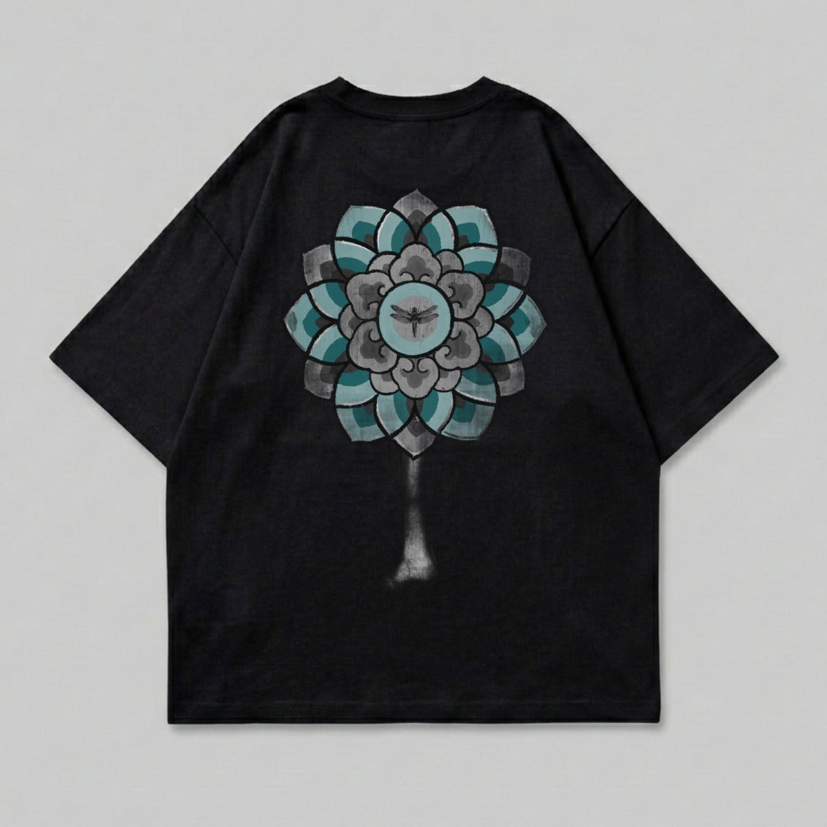 Black t-shirt with a large, grey and teal mandala design on the back.