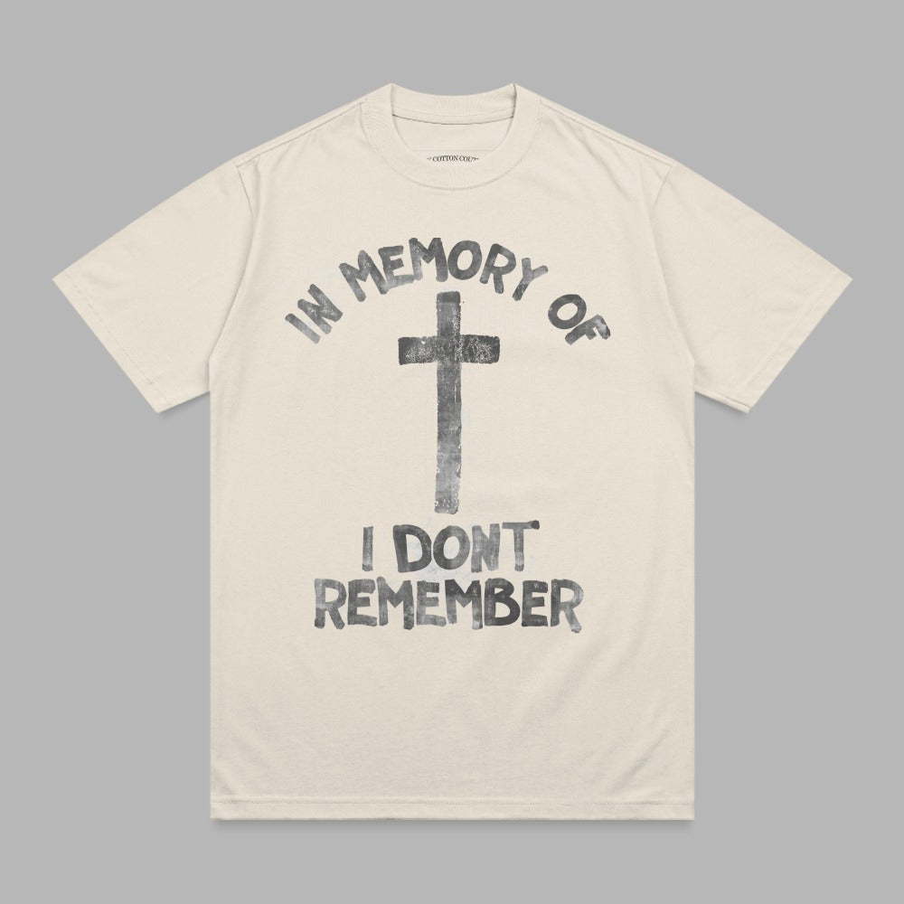 Cream t-shirt with black graphic of a cross and text "IN MEMORY OF I DON'T REMEMBER".