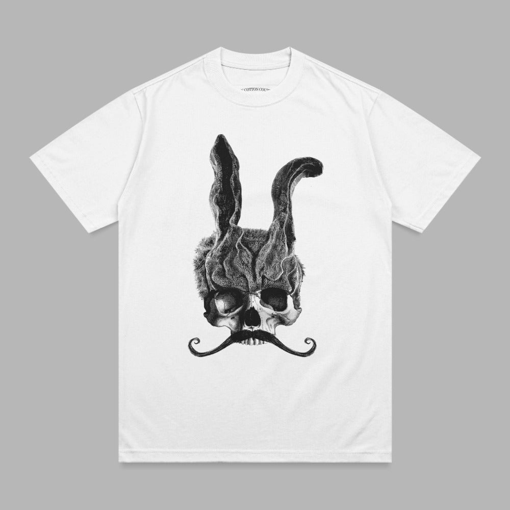 White t-shirt with a black illustration of a skull wearing rabbit ears and a mustache.