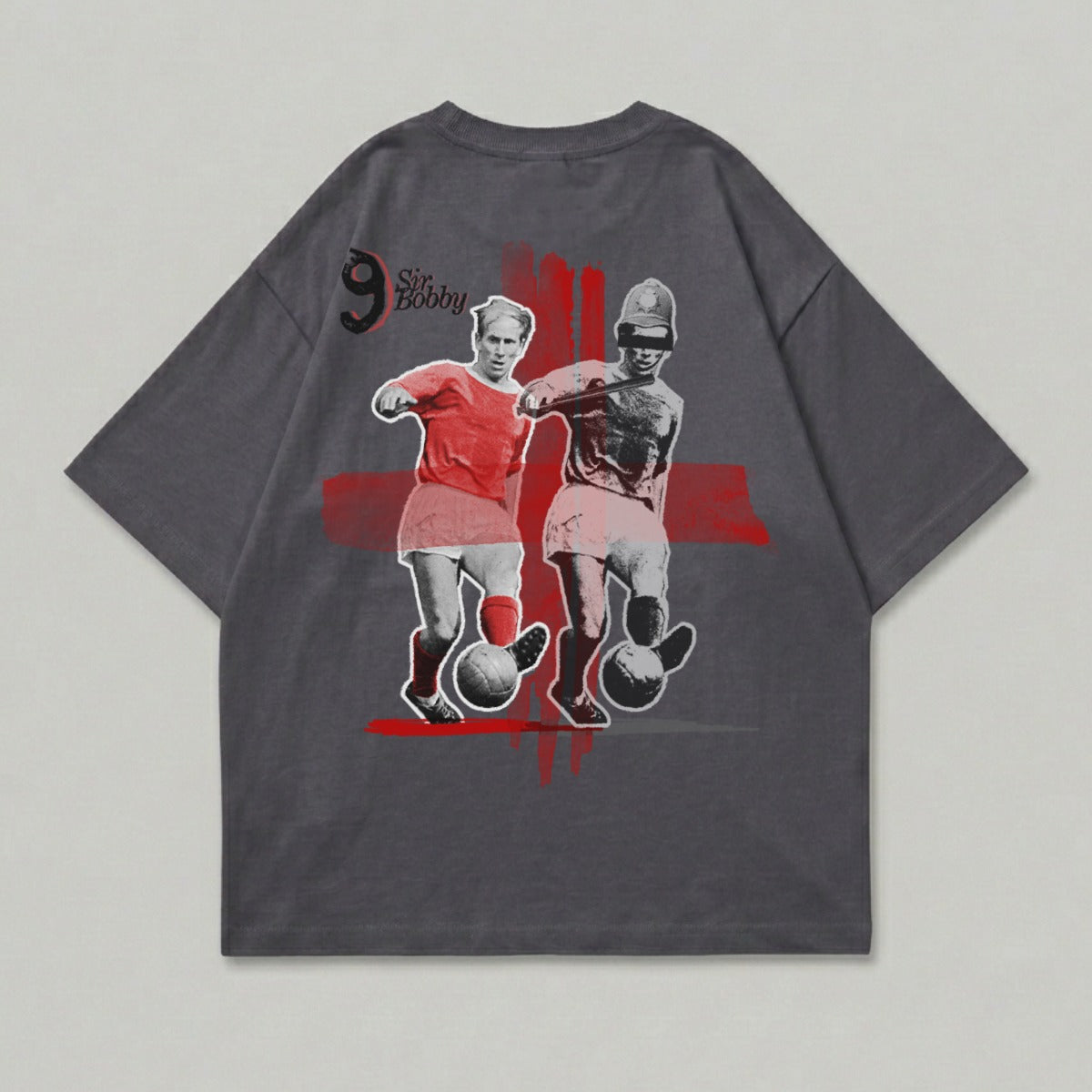 T-shirt graphic of Sir Bobby Charlton in red kit, dribbling a soccer ball.