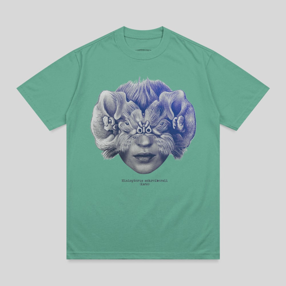 T-shirt with surreal art of a face with eyes and ears replaced by stylized animal heads.