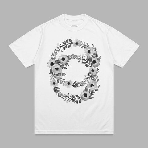 White t-shirt with a black and white floral wreath design on the front.