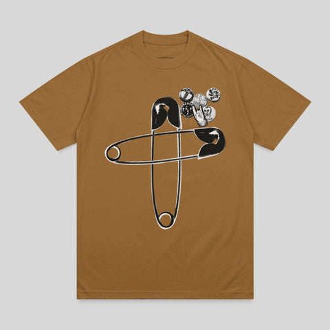 Brown t-shirt with a large safety pin and punk rock-style pins.