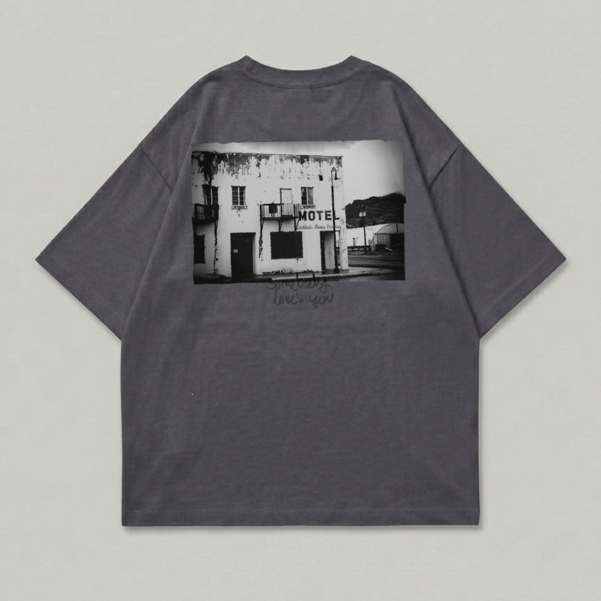 Dark grey t-shirt with black and white image of a motel and text.