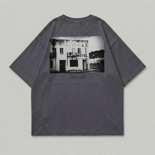 Dark grey t-shirt with black and white image of a motel and text.