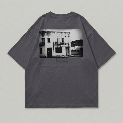 Dark grey t-shirt with black and white image of a motel and text.