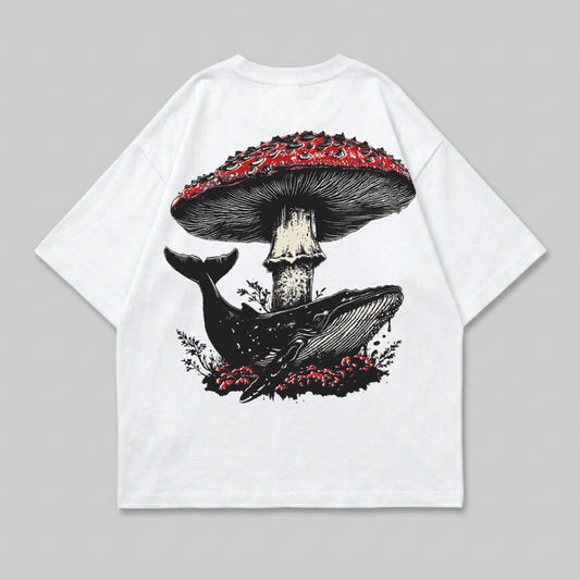 White t-shirt with a whale swimming under a large red mushroom.
