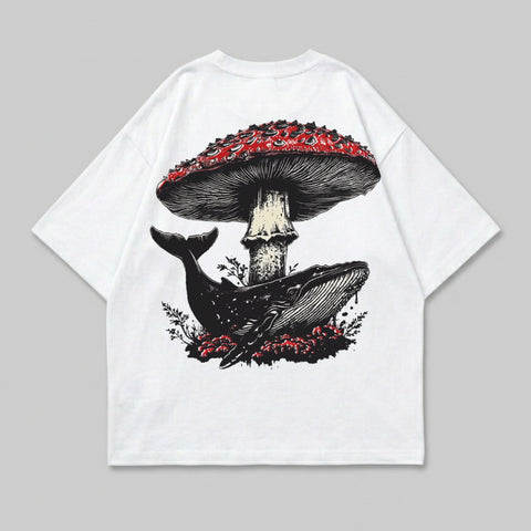 White t-shirt with a whale swimming under a large red mushroom.