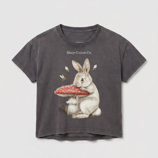 Gray t-shirt with a white rabbit sitting on a mushroom, and two bees.