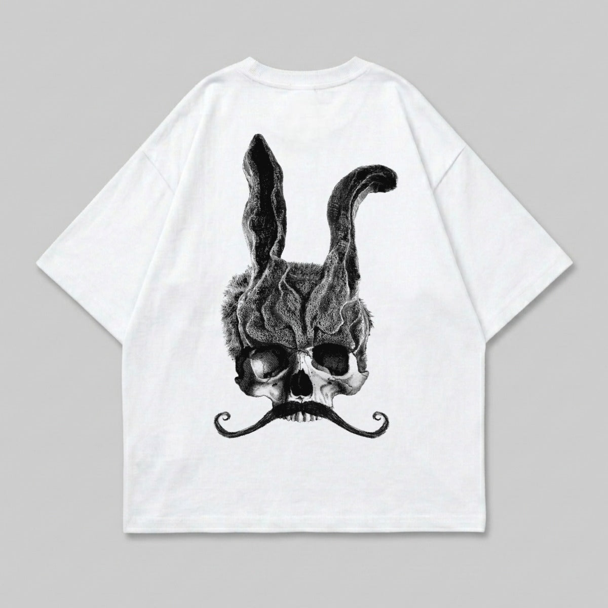 White t-shirt featuring a skull with rabbit ears and a mustache.
