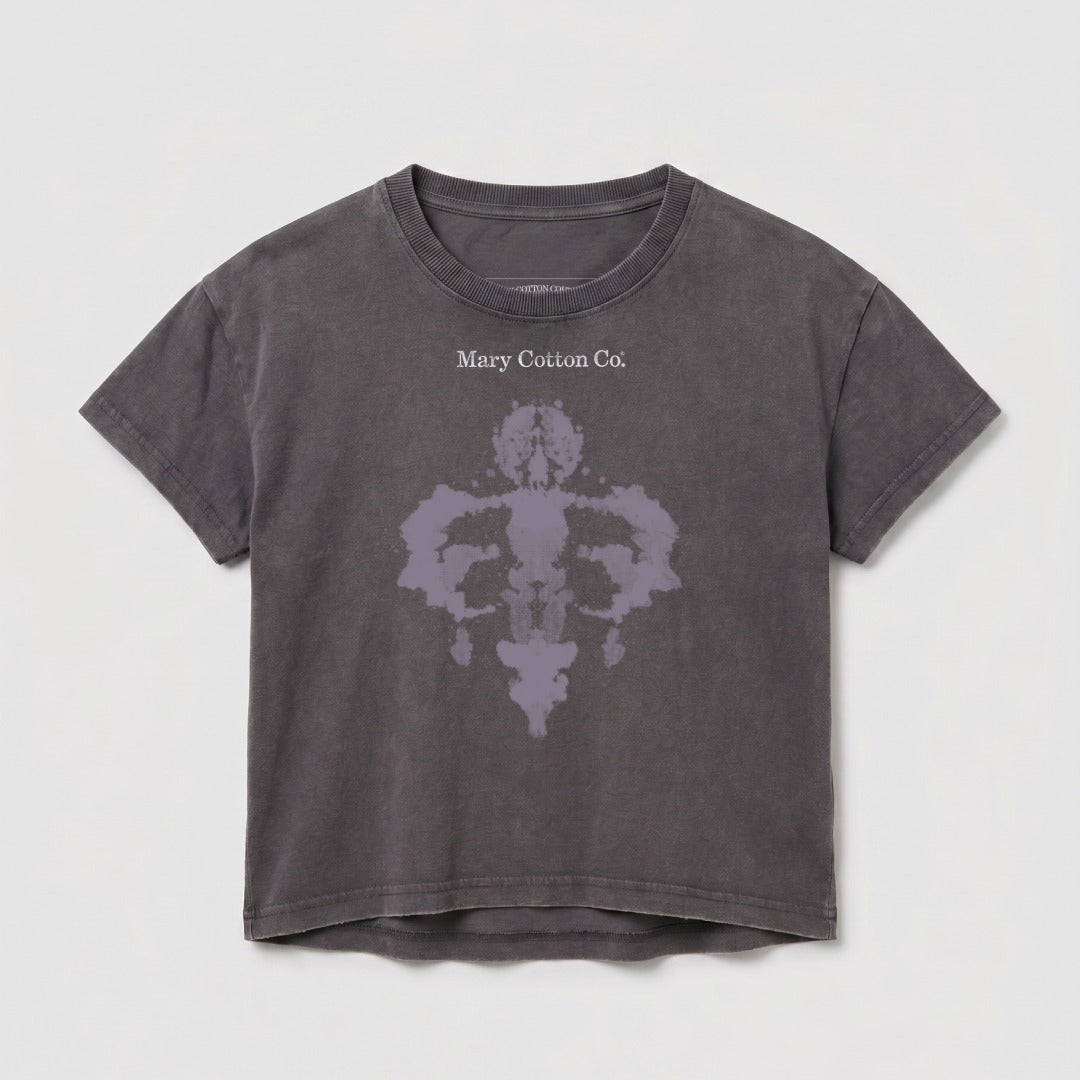 Grey cropped t-shirt with a Rorschach-style ink blot design and "Mary Cotton Co." text.