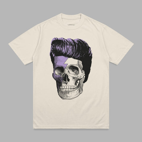 T-shirt with a cream color and a vintage skull with purple hair and a lightning bolt.