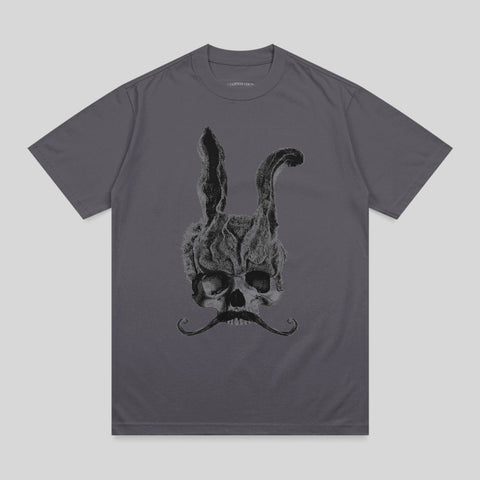 Skull with rabbit ears and mustache, smoke rising from head.