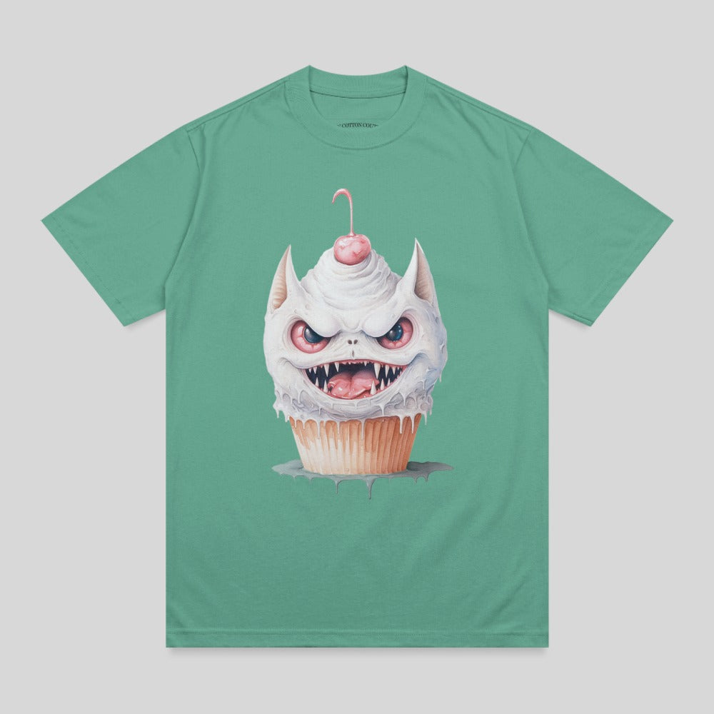 Monster cupcake with cherry on top, illustrated on a teal t-shirt.