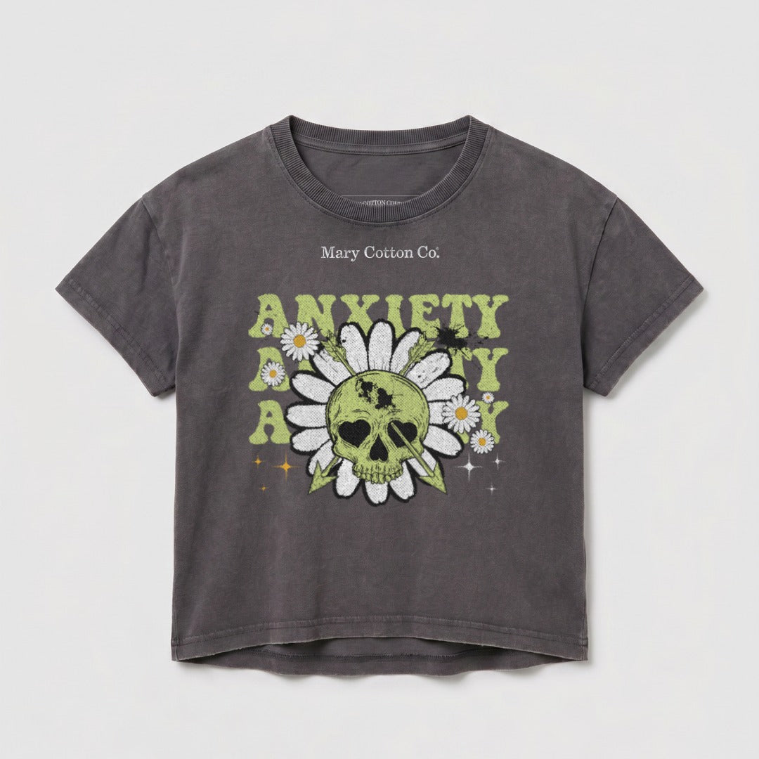Dark grey t-shirt with skull, daisies, and "Anxiety Kills" text graphic.