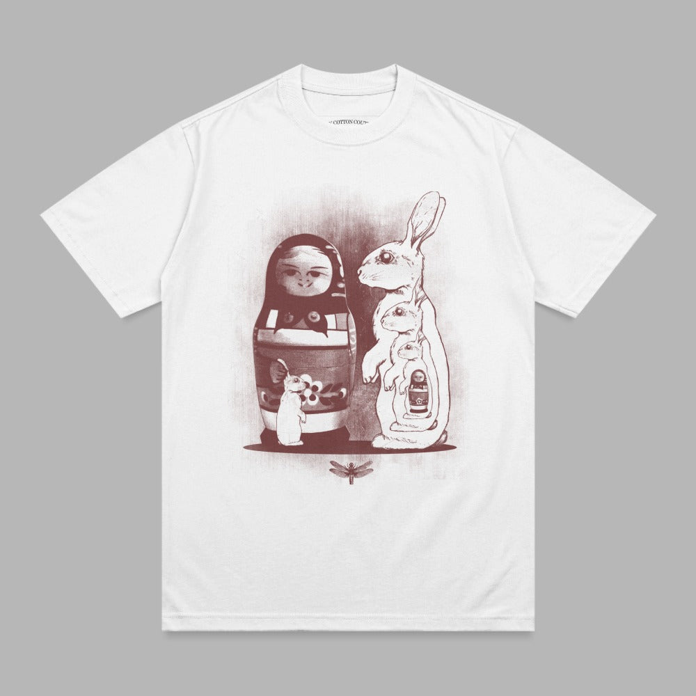 White t-shirt with matryoshka doll and rabbits illustration.