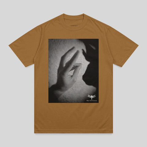 Brown t-shirt with a black and white graphic of a hand casting a shadow.