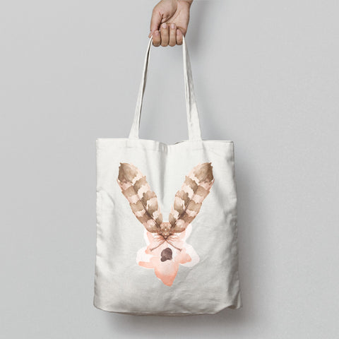 Hand Holding Tote Bag With Artistic Feather Design
