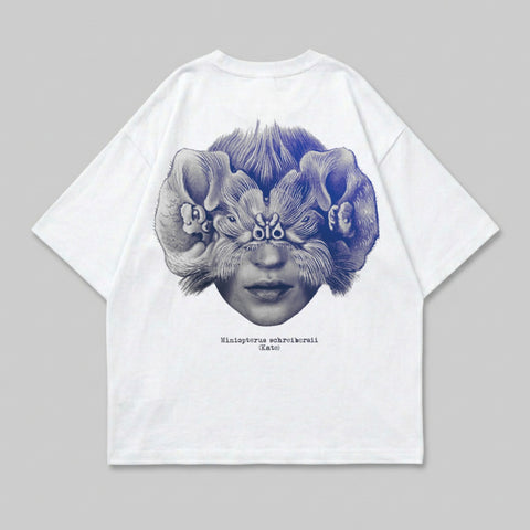 White t-shirt with a surreal illustration of a face with large furry ears.