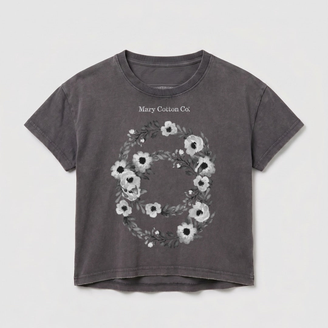 Dark grey cropped t-shirt with a floral wreath and "Mary Cotton Co." text.