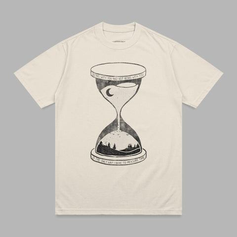 Cream t-shirt with hourglass illustration and text about time.