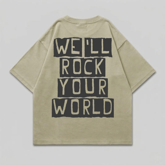 Tan t-shirt with bold black text that reads "WE'LL ROCK YOUR WORLD".