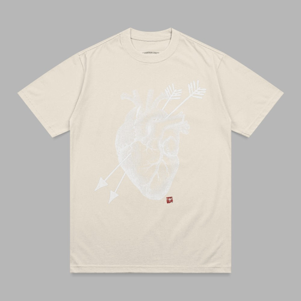 Cream t-shirt with a white anatomical heart and arrows graphic.