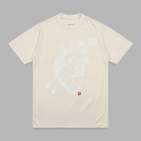 Cream t-shirt with a white anatomical heart and arrows graphic.