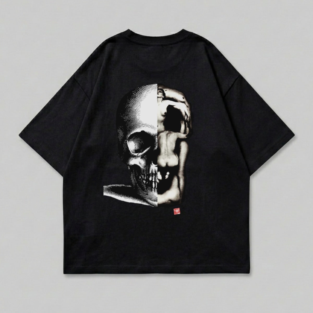 Black t-shirt with split skull and human figure graphic.