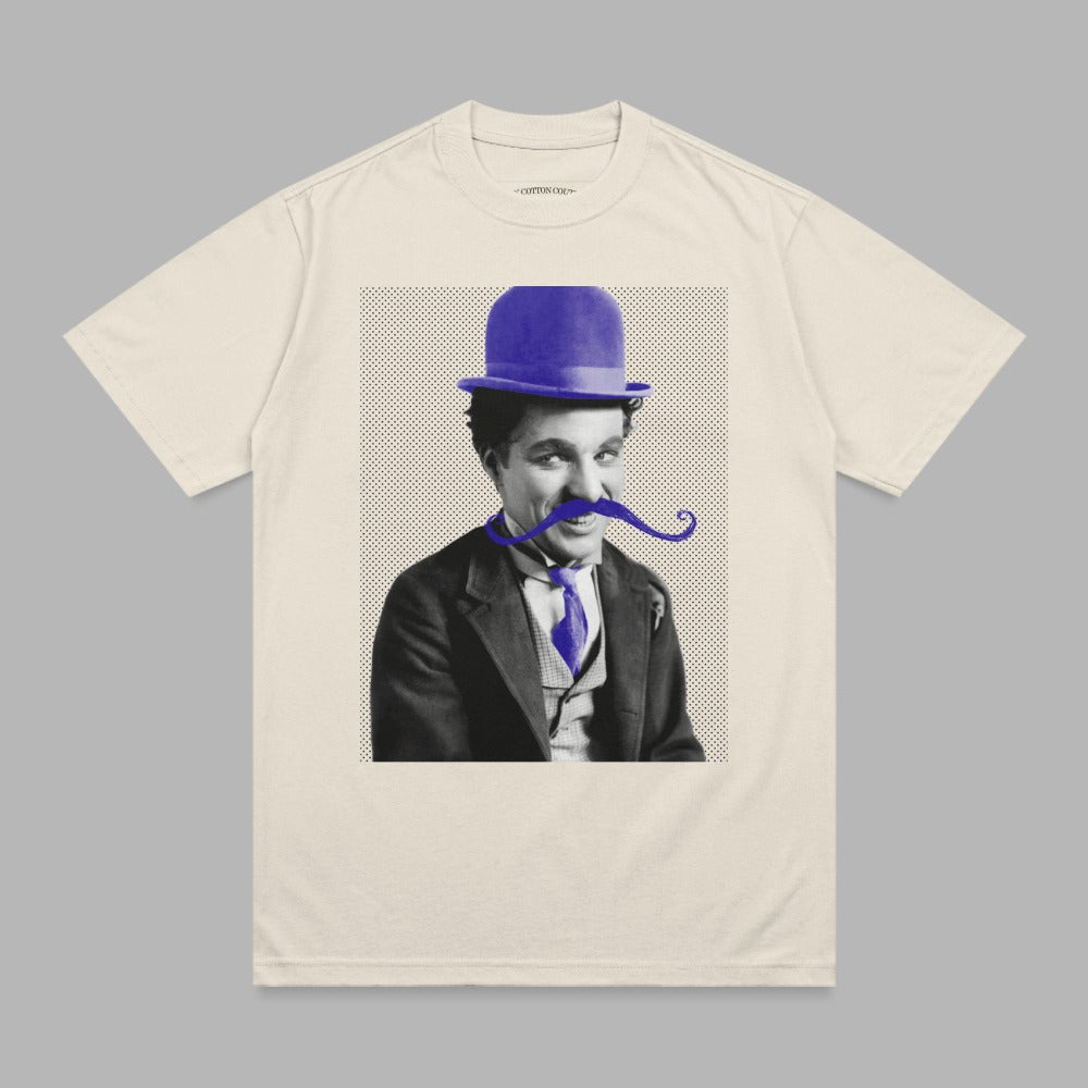 Charlie Chaplin in bowler hat and mustache on cream t-shirt.