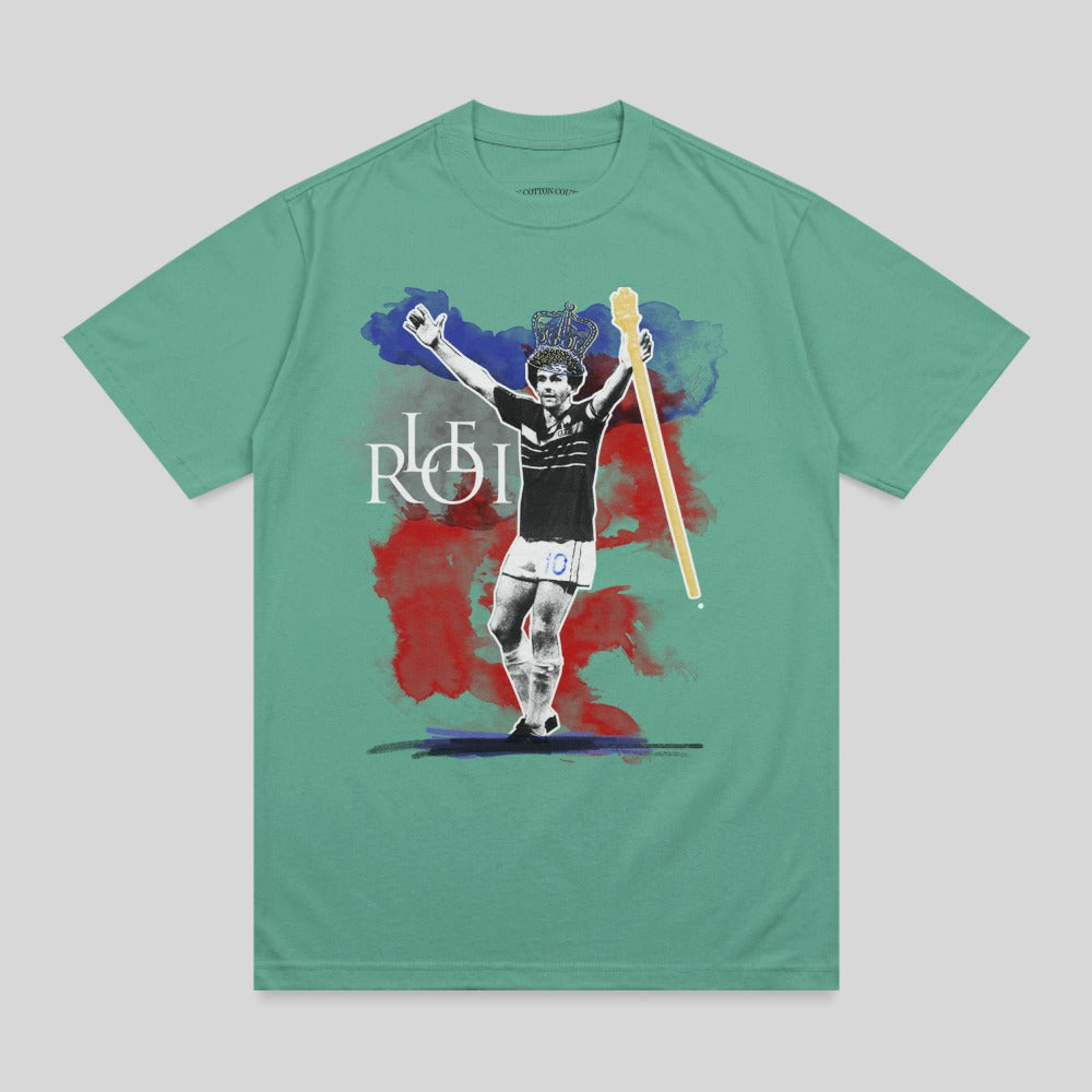 T-shirt graphic of soccer player with crown and scepter, "ROI" text.