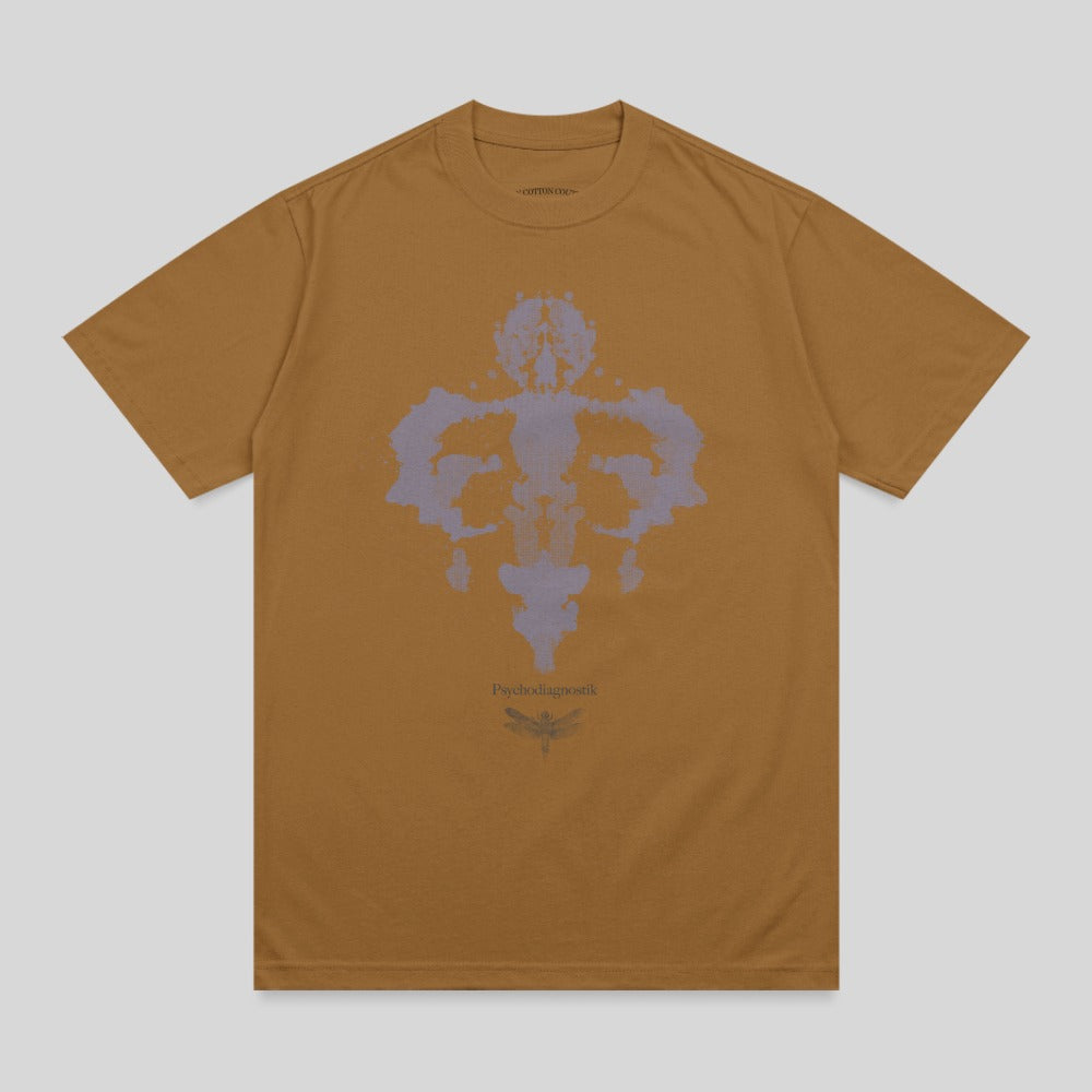 Brown t-shirt with a Rorschach inkblot and dragonfly graphic.