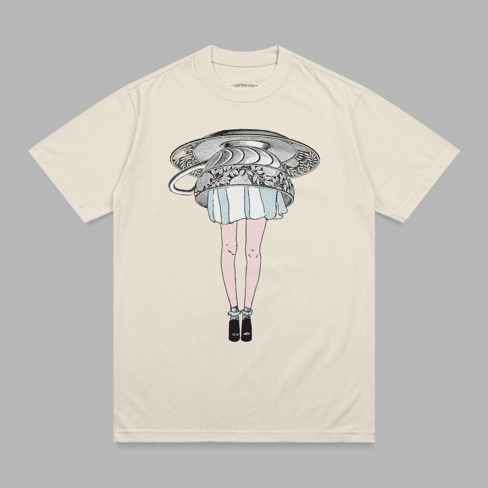Cream t-shirt with illustration of woman's legs wearing dress and heels, and a teapot.