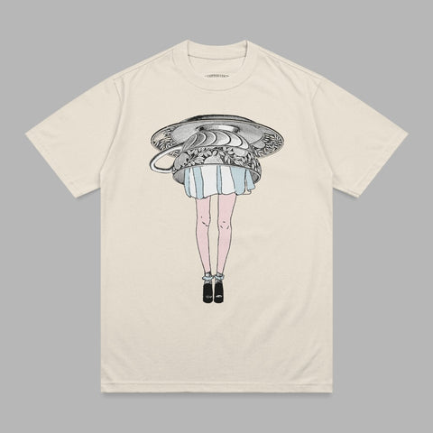 Cream t-shirt with illustration of woman's legs wearing dress and heels, and a teapot.