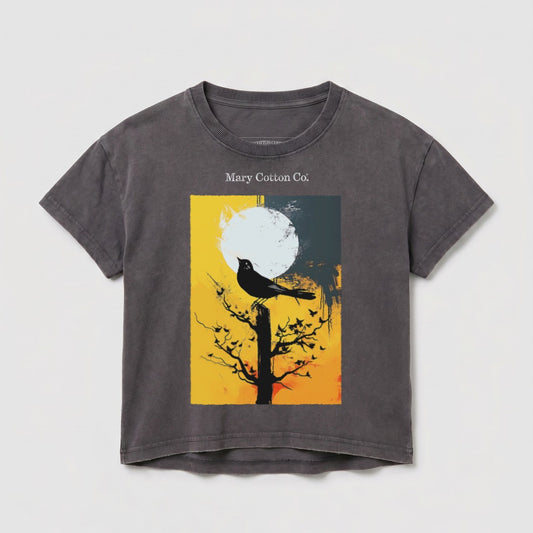 Dark t-shirt with a graphic of a bird on a tree branch against a stylized moon.
